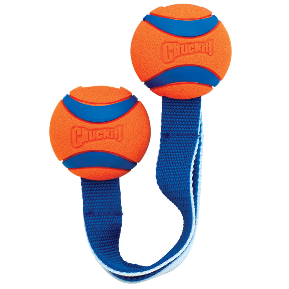 The Chuckit! Ultra Duo Tug Dog Toy by Chuckit features two orange and blue balls connected by a strong nylon strap, ideal for tugging. Its textured, grooved surfaces enhance grip with Chuckit! embossed for durability, making it perfect for energetic interactive play.
