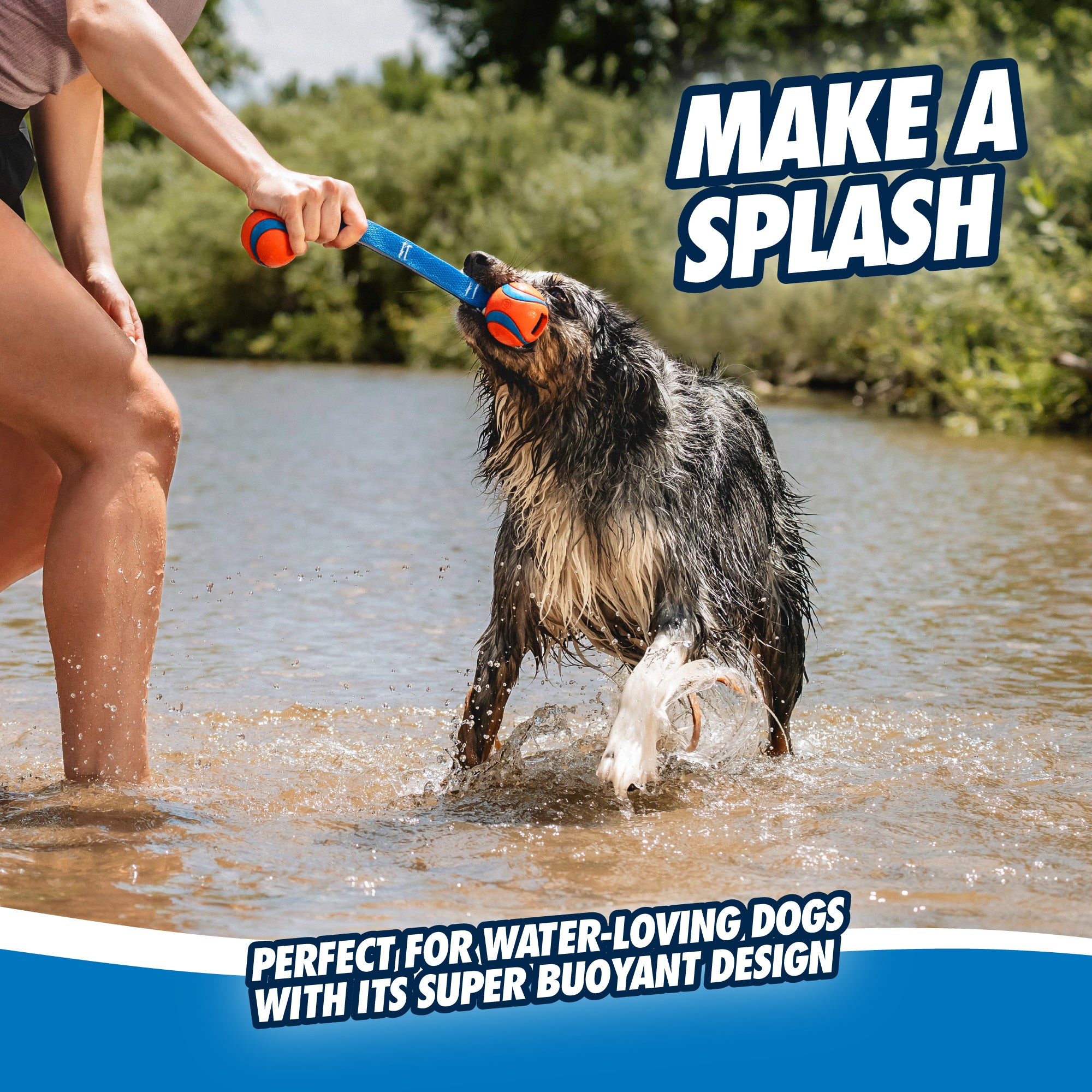 A wet dog grips a Chuckit Ultra Duo Tug Dog Toy in its mouth while a person holds the handle, standing in a river with trees lining the bank. The text reads MAKE A SPLASH and highlights its super buoyant and durable design, perfect for water-loving dogs.