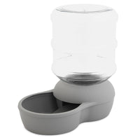 The Aspen Pet Lebistro Waterer by Aspen Pet is a transparent, BPA-free plastic dispenser with a large jug and gray base, featuring a spill-resistant lip and bowl for easy pet access.