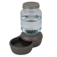 The Petmate 1-Gallon Mason Jar Gravity Pet Waterer by Petmate features a BPA-free plastic mason jar on a sleek gray base with a bowl for easy dispensing and includes a charcoal filter to provide clean, fresh water for your pet.