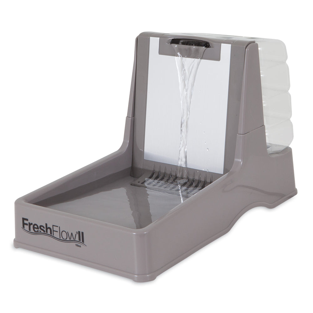 The Petmate Fresh Flow II Dog & Cat Water Fountain in gray features a cascading waterslide for splash-free drinking, includes a clear, detachable reservoir for filtered water, and boasts a sloped design for easy pet access.