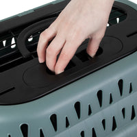 A close-up of a hand operating the black latch on the Petmate E-Z Load Top Load Cat Kennel, featuring triangular holes for 360-degree ventilation to ensure your pet’s comfort and stress-free travel.