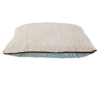 The Petmate Two-Sided Fashion Dog Pillow Bed by Petmate features a washable, beige textured top and patterned blue bottom with slightly rounded edges, offering a soft and comfortable spot for pets seeking cozy rest.