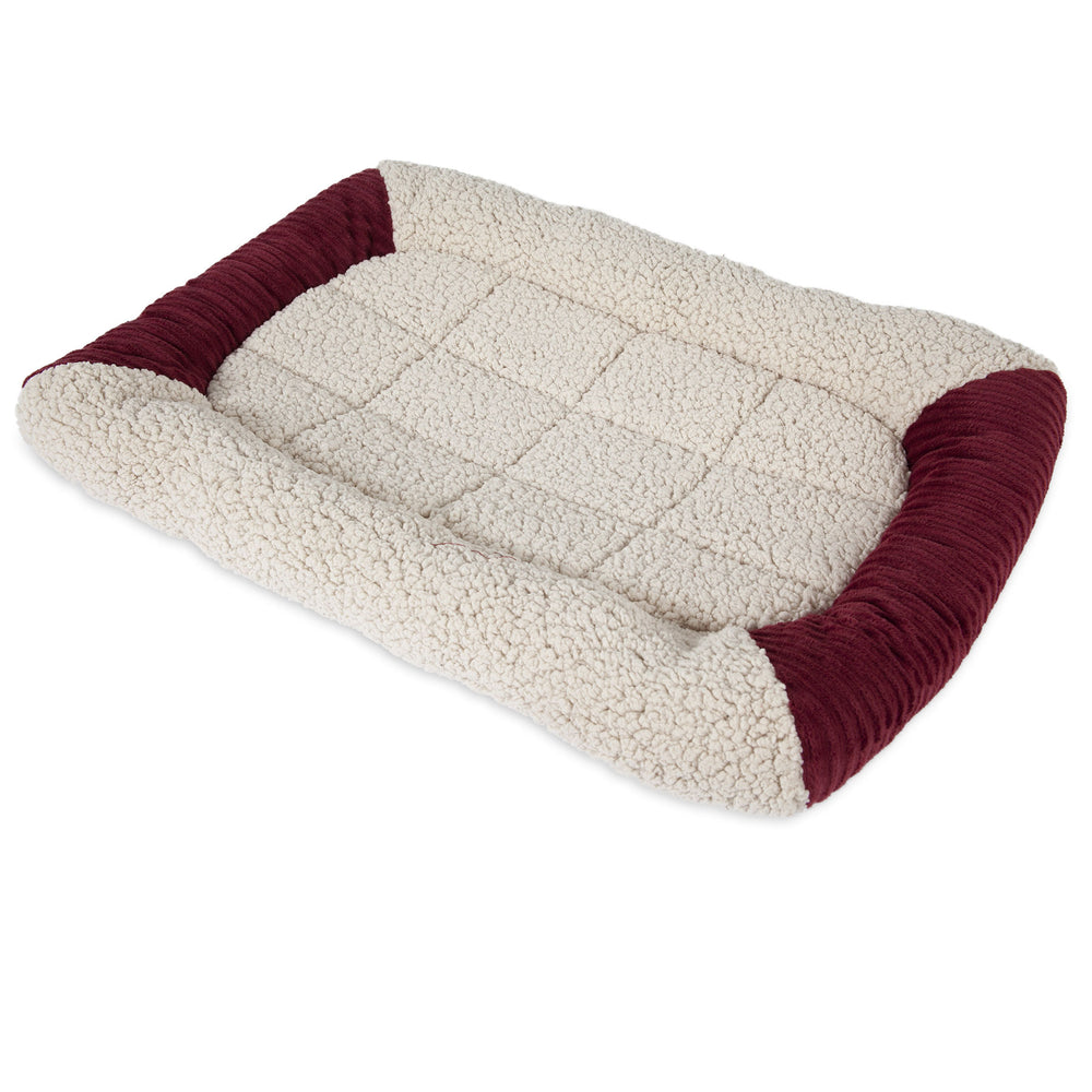 The Aspen Pet Self-Warming Bolster Mat by Aspen Pet features a plush, cream quilted surface with raised maroon sides and a self-warming bolster. Its Mylar interior provides warmth and comfort, making it perfect for small to medium-sized pets.