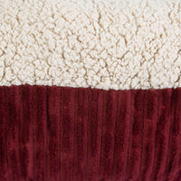 Close-up of the Aspen Pet Self-Warming Bolster Mat, featuring a plush textured fabric ideal for kennel mats. The top is cream-colored, resembling soft fleece, and the bottom is burgundy with a ribbed pattern.