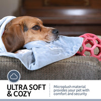 A dog relaxes on a couch covered in the PetFusion Premium Reversible Micro Plush Dog Blanket, with a red toy ball nearby. Text reads Ultra Soft & Cozy, highlighting the comfort and security for pets while also serving as a furniture protector.
