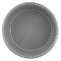 A top view of an empty, round gray ceramic bowl with a smooth, glossy surface complements any kitchen decor when paired with Petmate Painted Stainless Steel Pet Bowls by the brand Petmate.