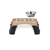 The Petmate Easy Reach Diner by Petmate is an elevated beige and black pet feeder with two stainless steel bowls, ideal for large breed dogs to aid digestion. An extra identical bowl sits beside the station, making it suitable for both dogs and cats.