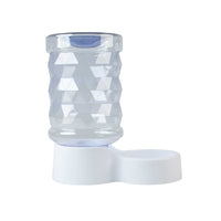 The PetFusion H2O Gravity Pet Water Dispenser features a transparent, textured design with a geometric pattern on a white base and an integrated small bowl. This BPA-free, 2.5-gallon waterer automatically dispenses water for furry friends.