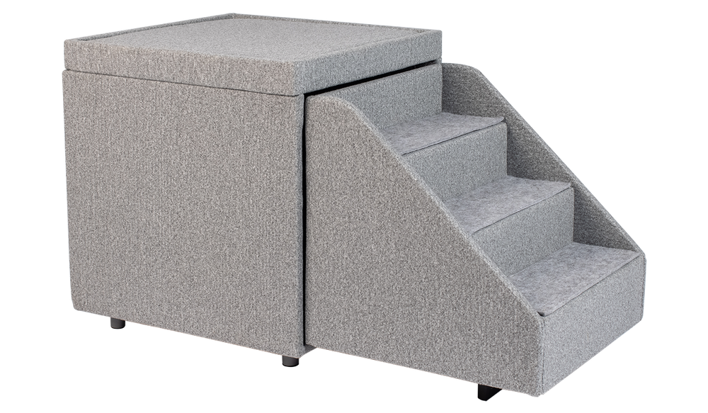 The PetFusion Multi-Purpose Pet Stairs, in premium gray with three steps and a textured fabric for durability, sits beside a soft cube-shaped ottoman, allowing pets to access higher surfaces safely.